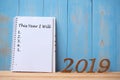 2019 Happy New years with notebook Ã¢â¬Å This Year I Will Ã¢â¬Å text and wooden number on table and copy space. Royalty Free Stock Photo